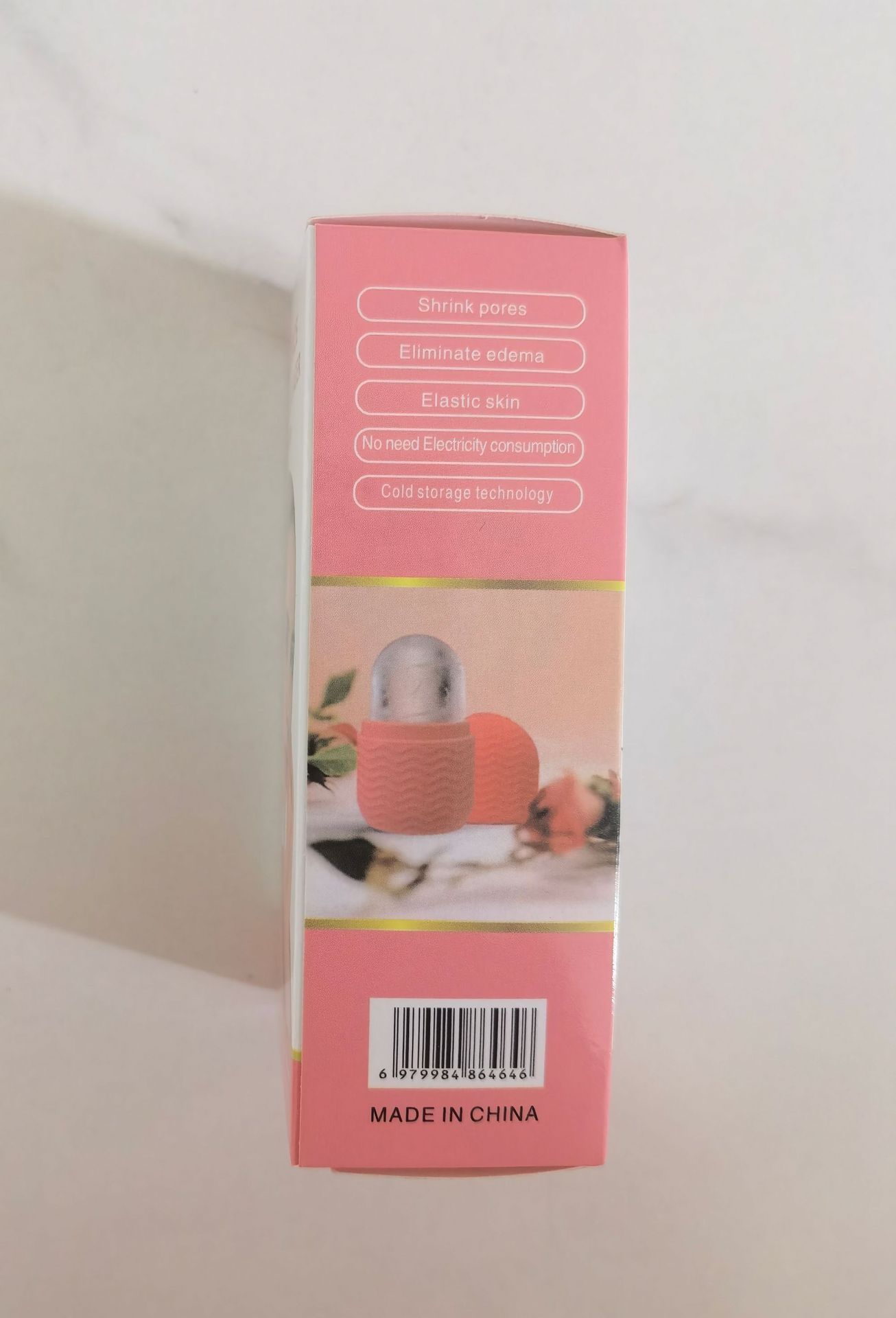 Facial ice roller for skin care in pink packaging showing product benefits and barcode