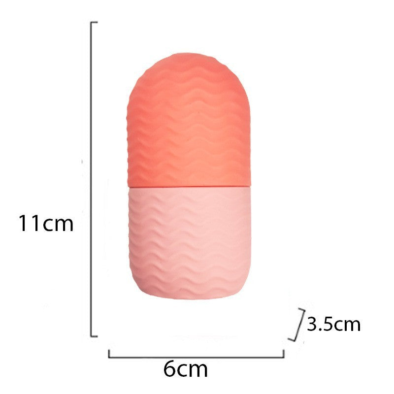 Compact pink and coral facial ice roller for skin care with textured grip and dimensions